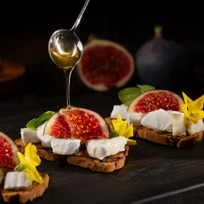 Figs on goat's cheese and artisan crackers, with drizzled honey