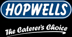 Logo for Hopwells, wholesale food suppliers to the catering industry. The word ‘HOPWELLS’ appears in bold white letters inside a blue oval, with the tagline “The Caterer’s Choice” beneath in a white script on a black background.