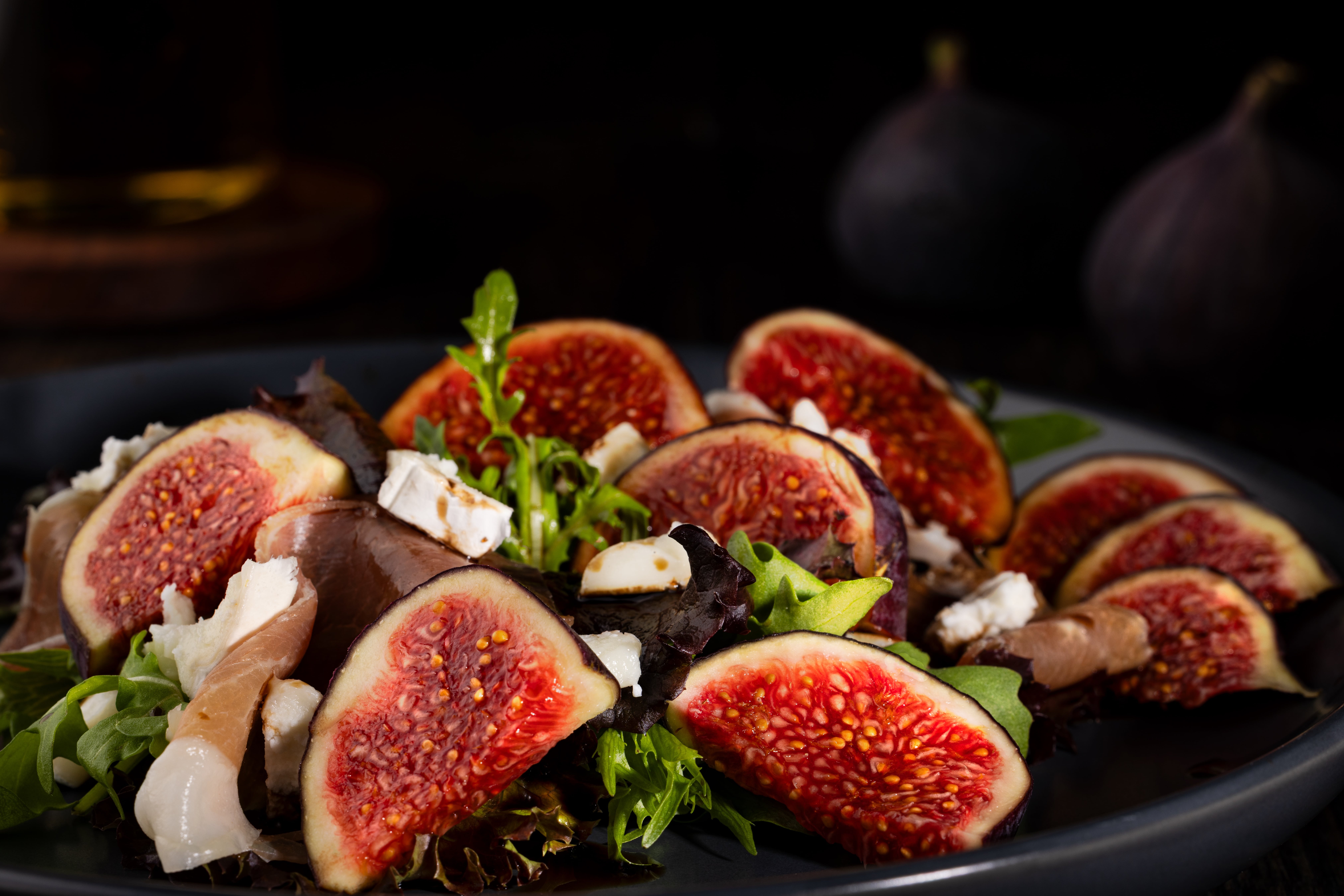 A salad of prosciutto, figs and goats cheese, with a balsamic drizzle. Styled and photographed by JaxMore Food and Drink Photography, in their Derby studio.