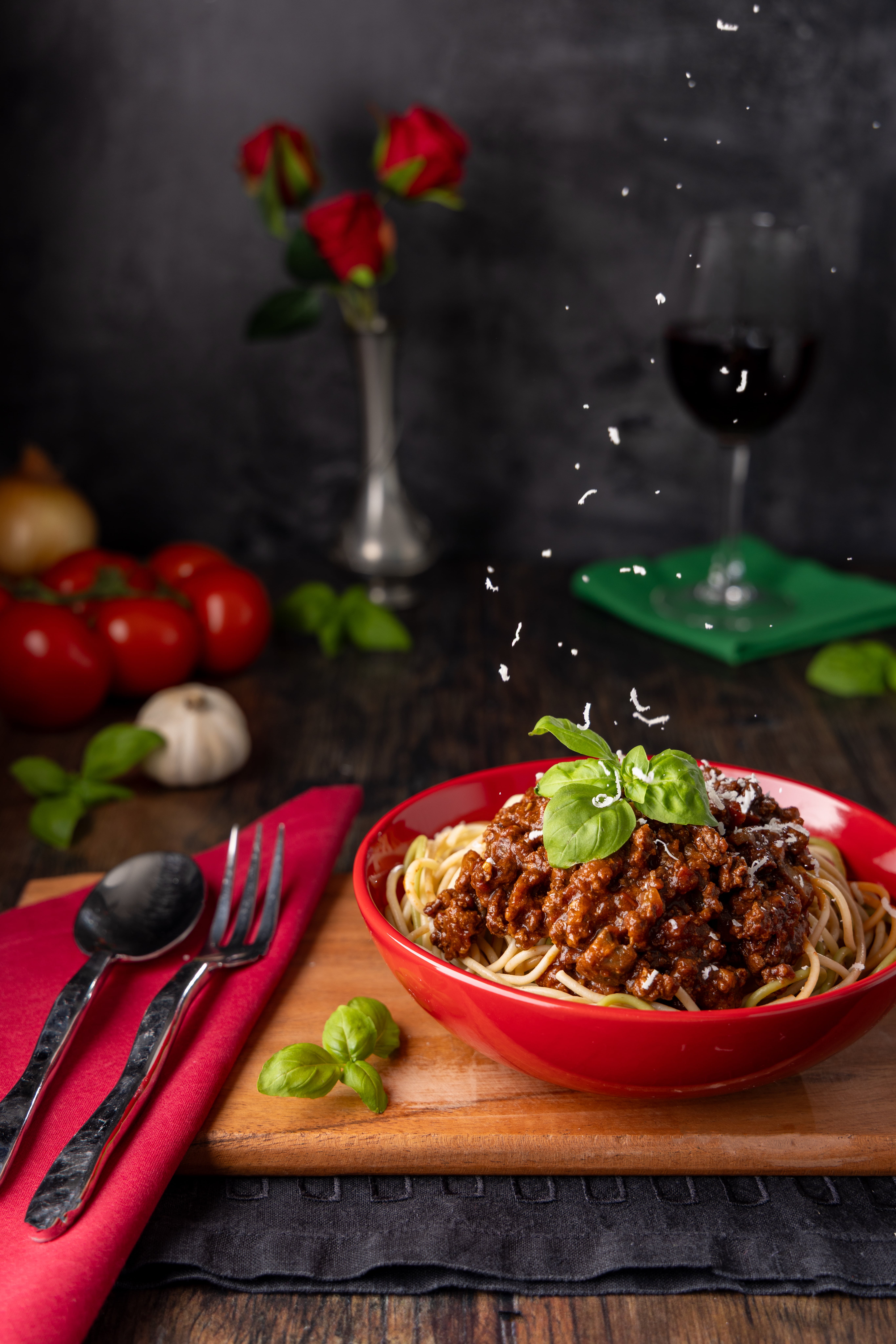Sophisticated Pasta Restaurant photograph, by JaxMore Food and Drink Photography. Catching parmesan as it falls adds movement and class.