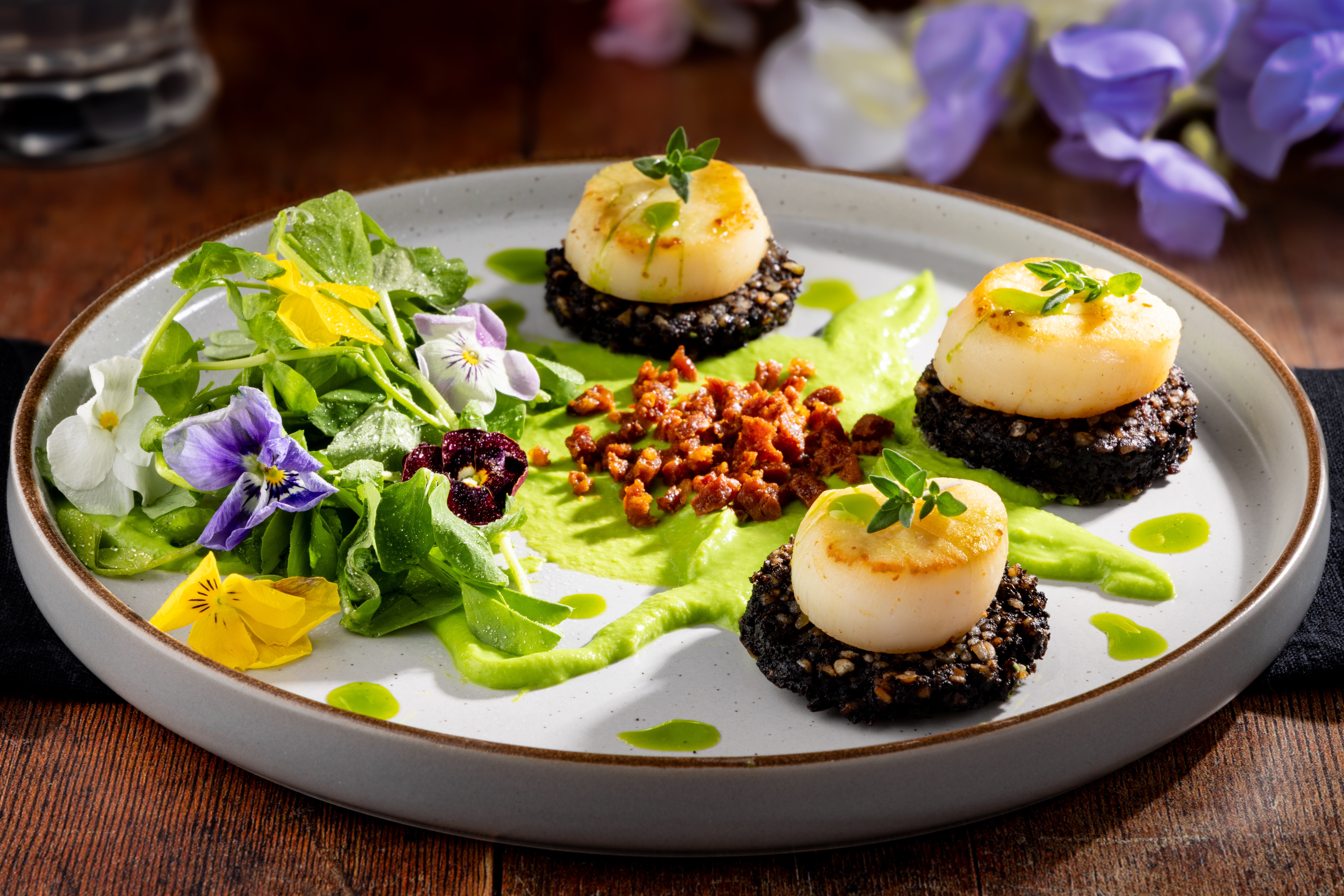 Seared Scallops, Black Pudding, Pea Purée, Pea Shoots and a Chorizo Crumb, styled and photographed by JaxMore Food and Drink Photography, in their Derby studio.