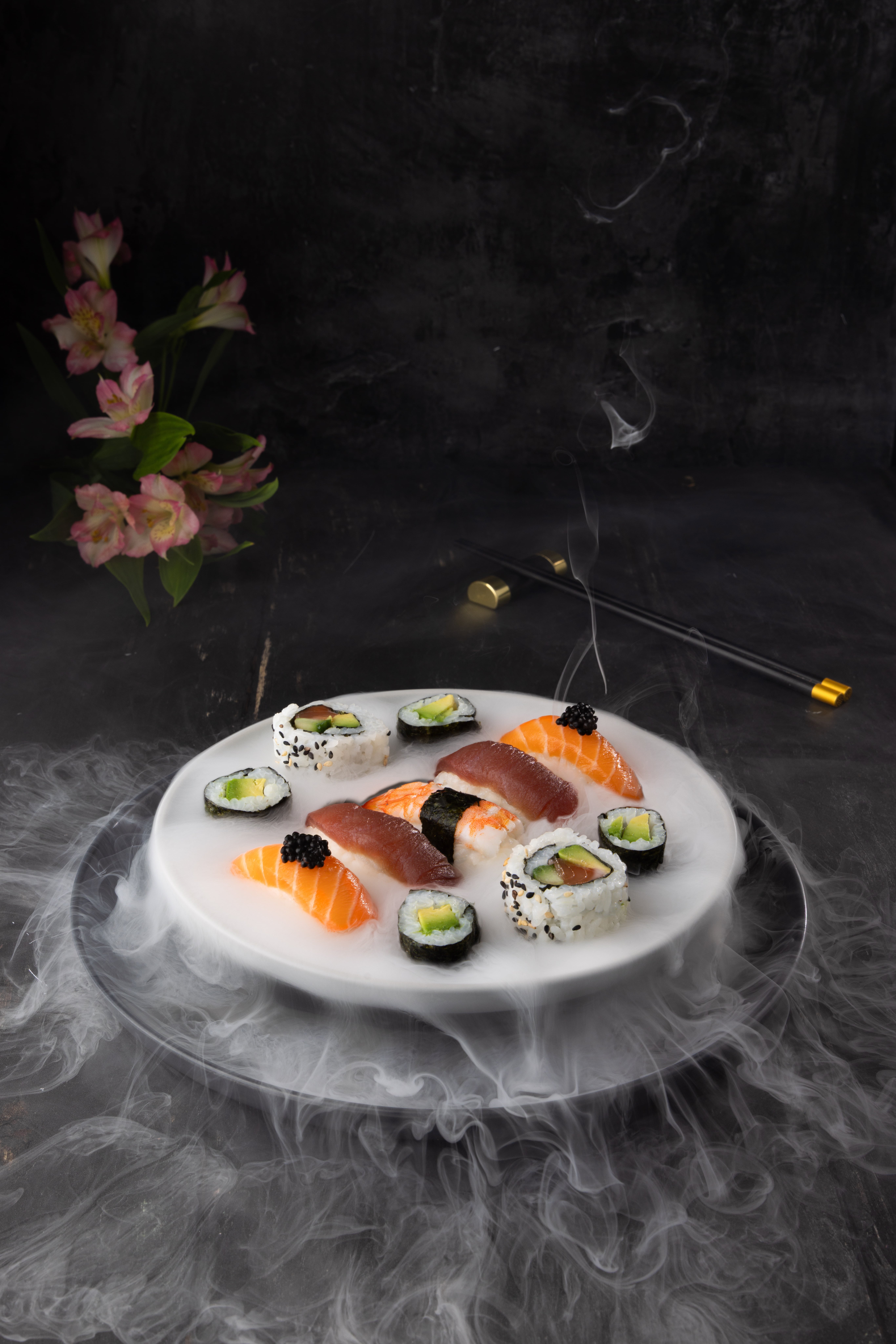 Elegant sushi platter, styled and photographed by JaxMore Food and Drink Photography. The dry ice adds really drama and impact to this scroll-stopping professional photograph.