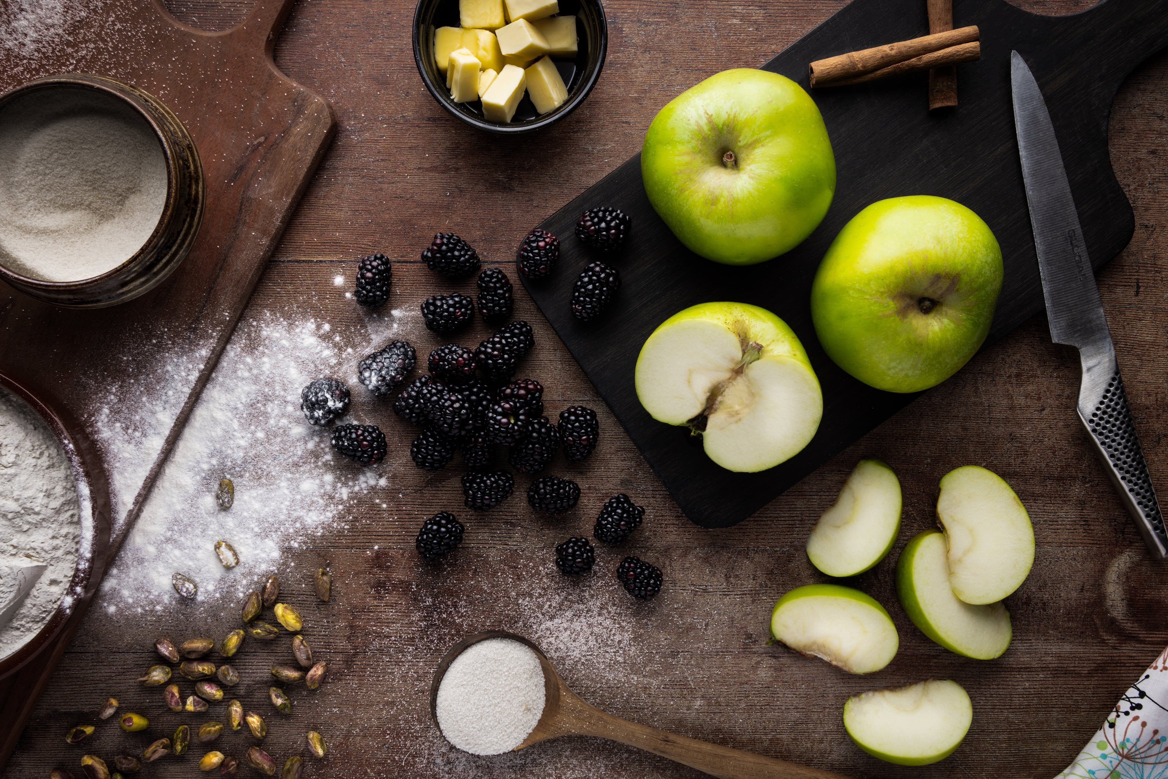Ingredients for an Apple and Blackberry Crumble, shot as a flat lay by JaxMore Food and Drink Photography, in their Derby studio.