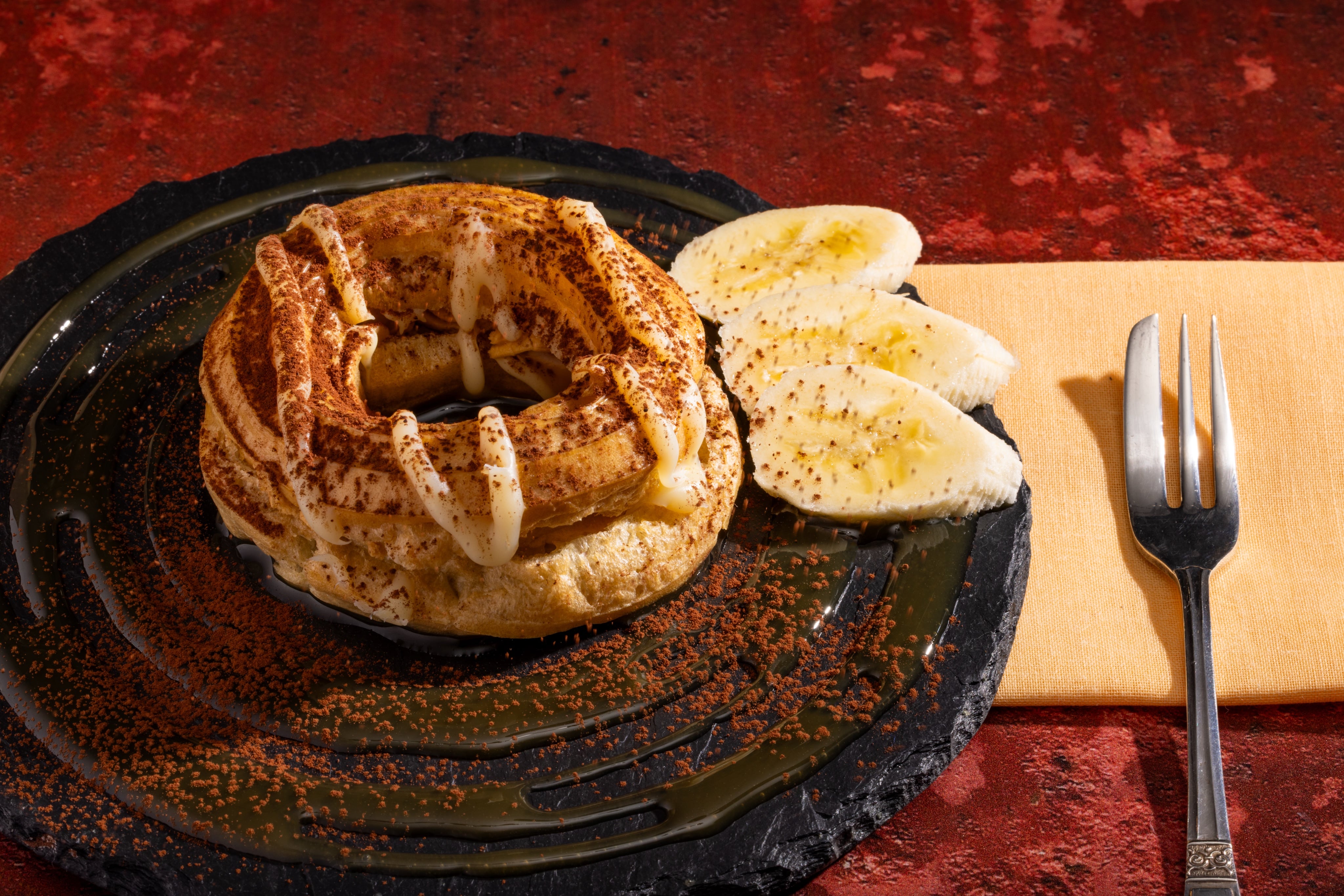 A Banana, Toffee and Chocolate Chouxnut. Pastry dessert photography by JaxMore Food and Drink Photography, in their Derby studio.