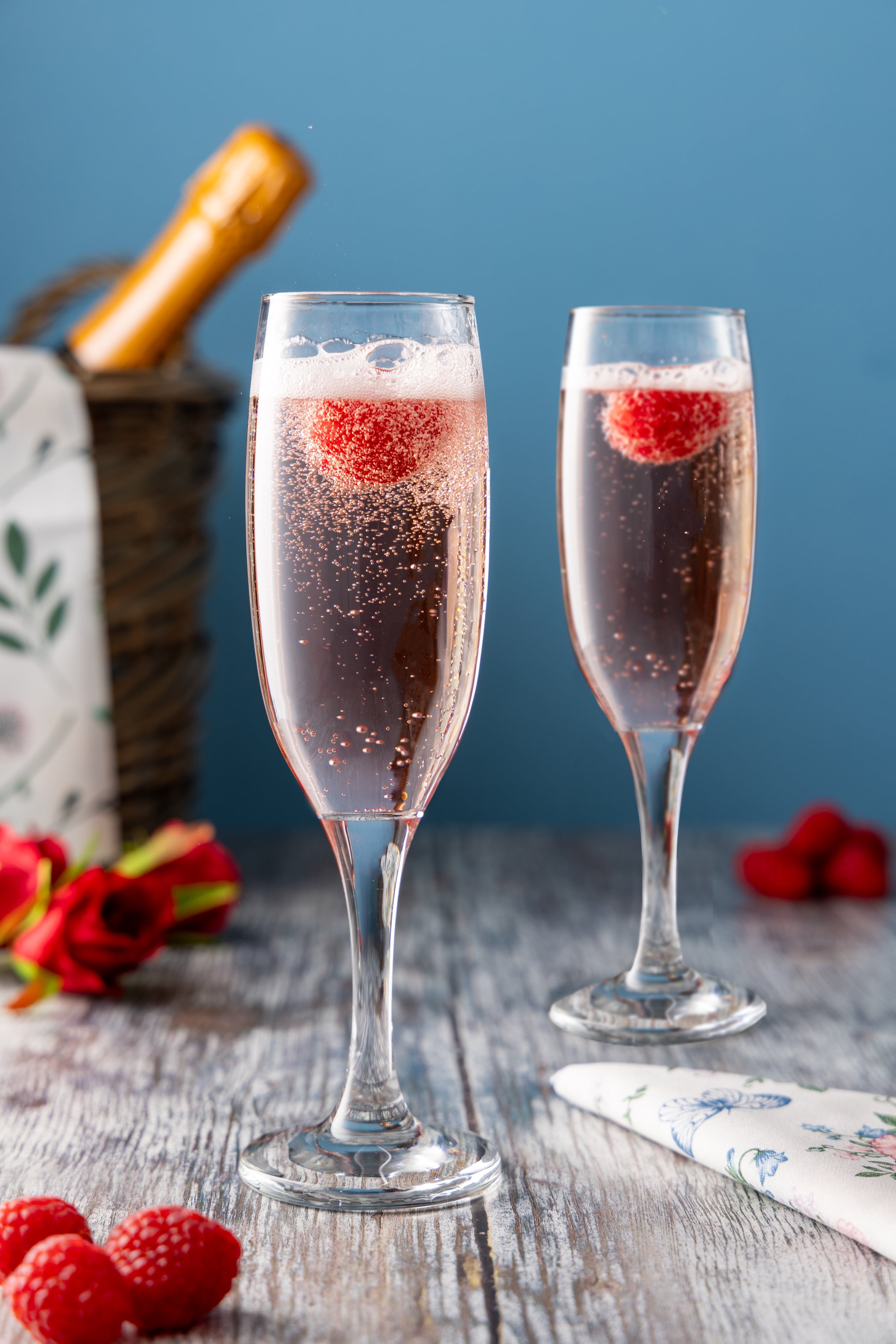 Picnic-ready raspberry bellinis. Creative photograph by JaxMore Food and Drink Photography, shot in their Derby studio.