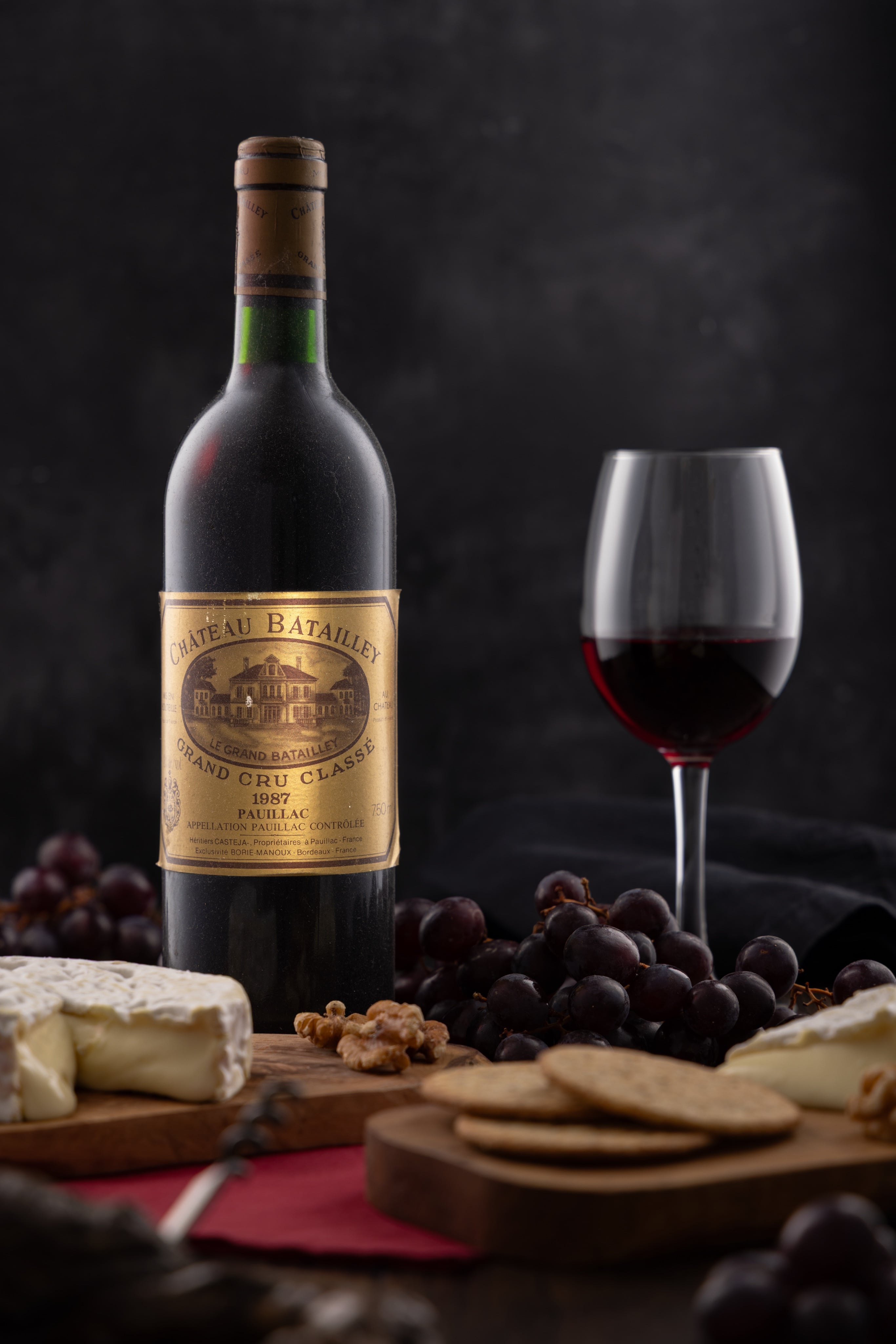 Fine wine, served with fine cheese. An elegant wine bottle photograph, by JaxMore Food and Drink Photography, shot in their Derby studio.