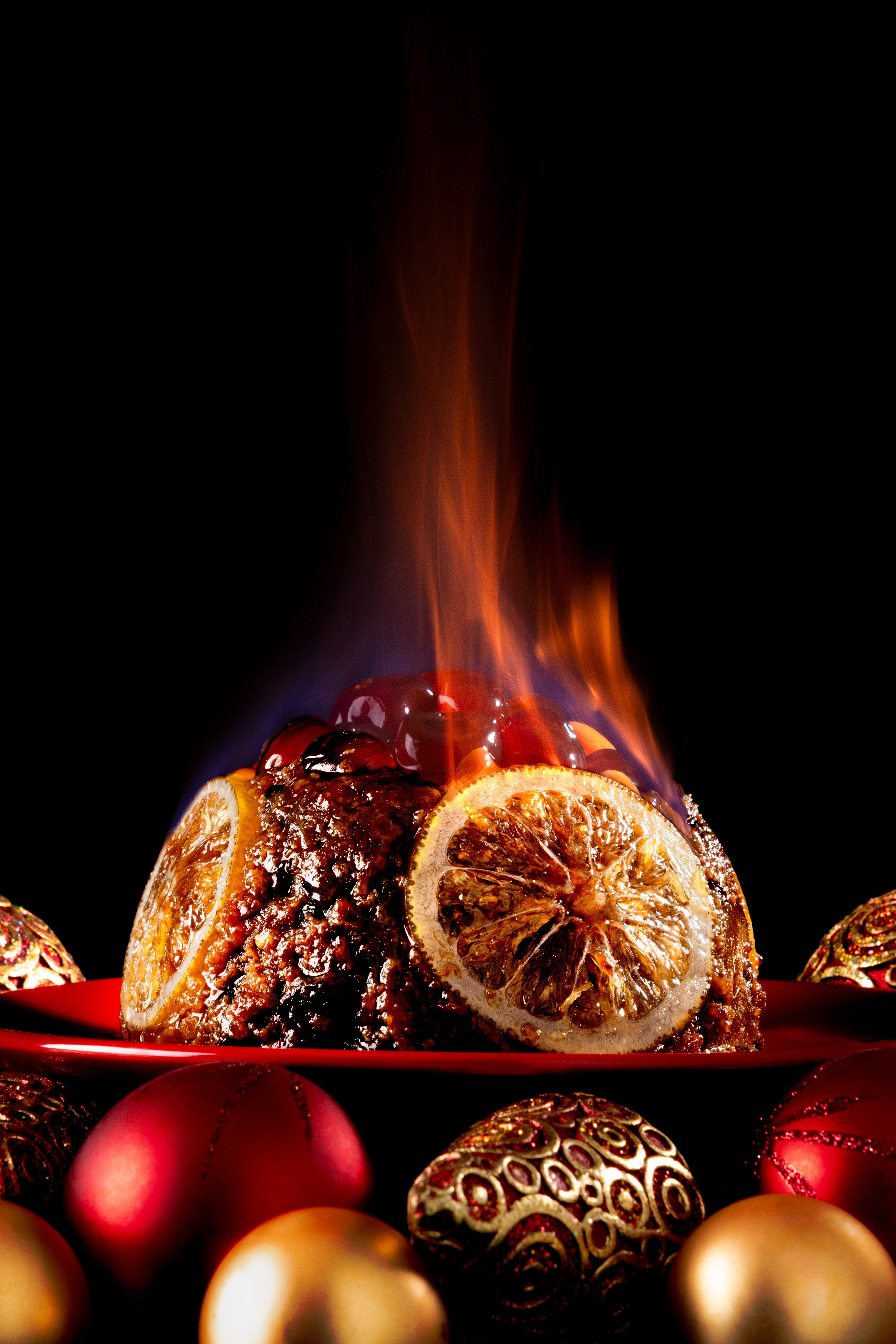 Flaming Christmas Pudding, delicious and full of spice and sparkle. Photographed by JaxMore Food and Drink Photography, in their Derby studio.