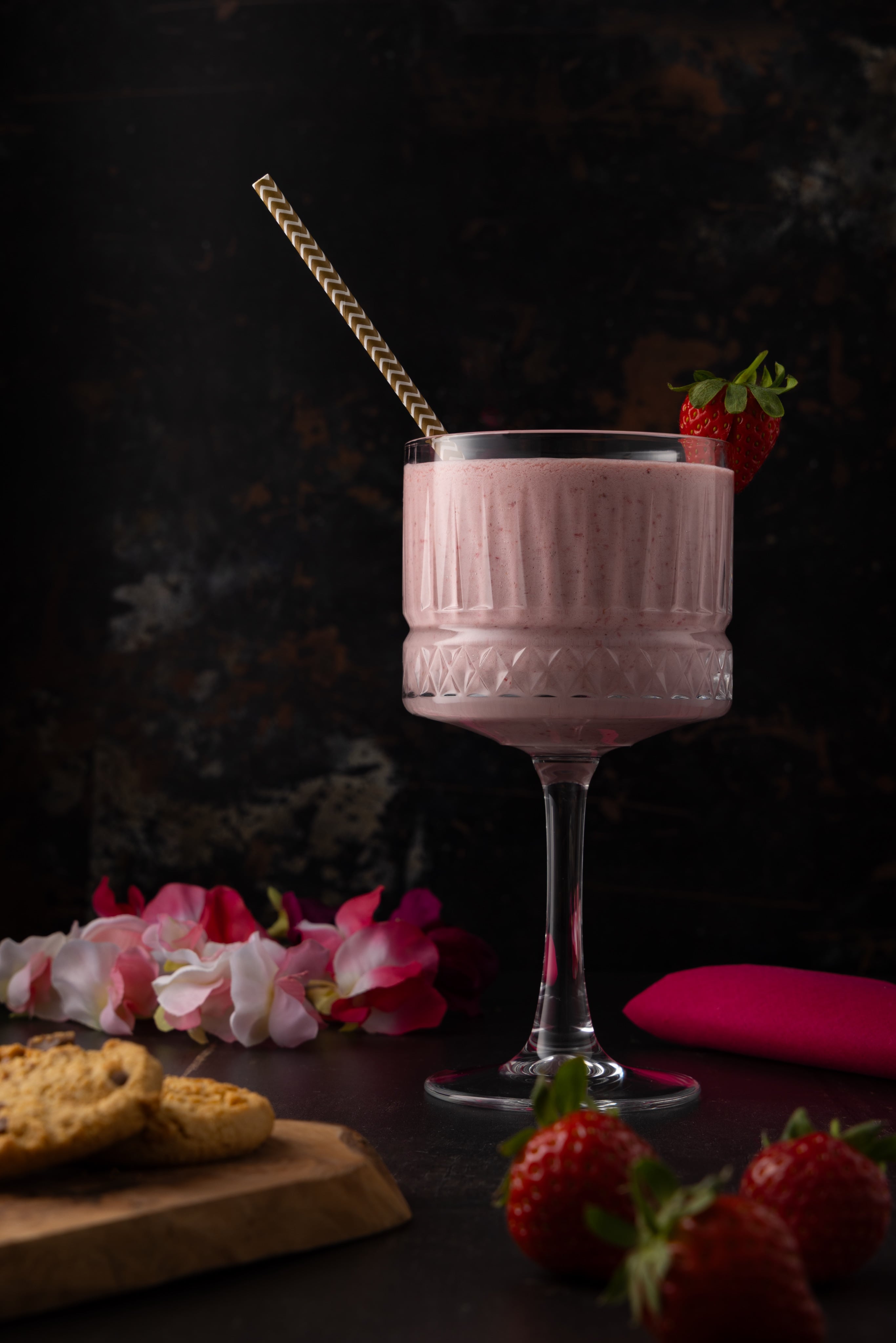 A delicious, sophisticated strawberry milkshake, shot in a dramatic, dark and moody style by JaxMore Food and Drink Photography, in their Derby studio.