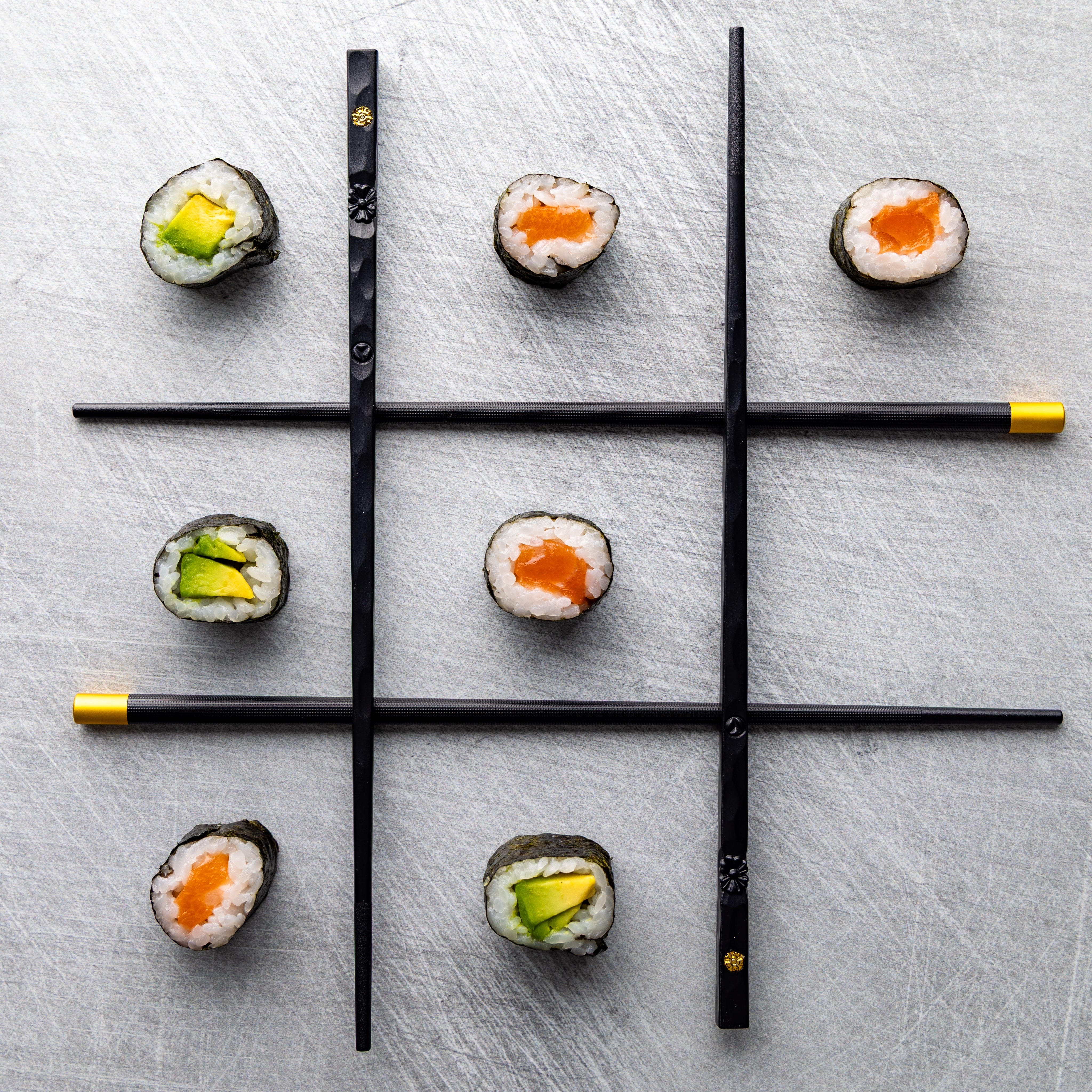 Creative playful photograph, playing noughts and crosses with sushi. By JaxMore Food and Drink Photography, shot in their Derby studio.