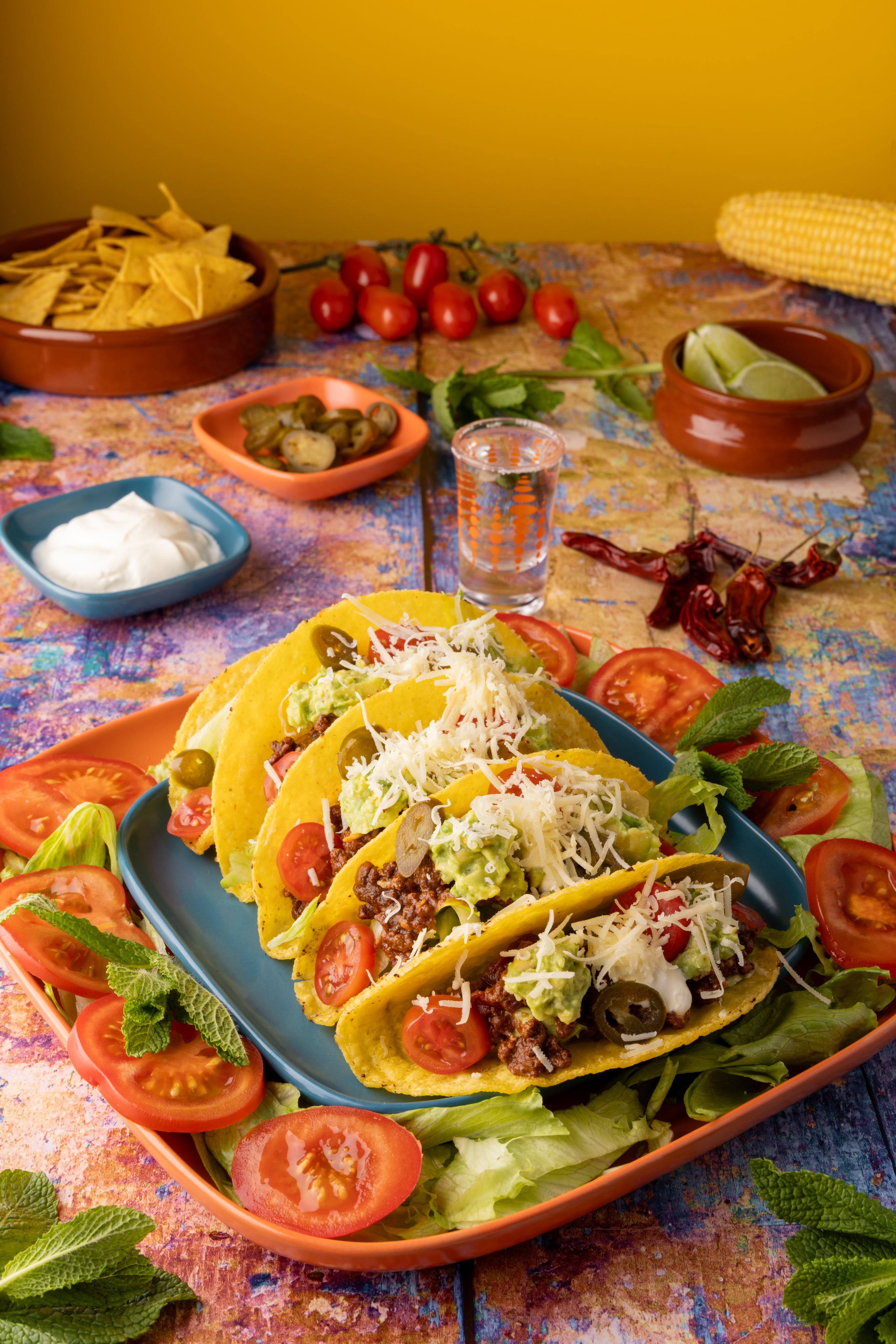 A Mexican Taco Feast. A creative photograph with vibrant colours, by JaxMore Food and Drink Photography, shot in their Derby studio.