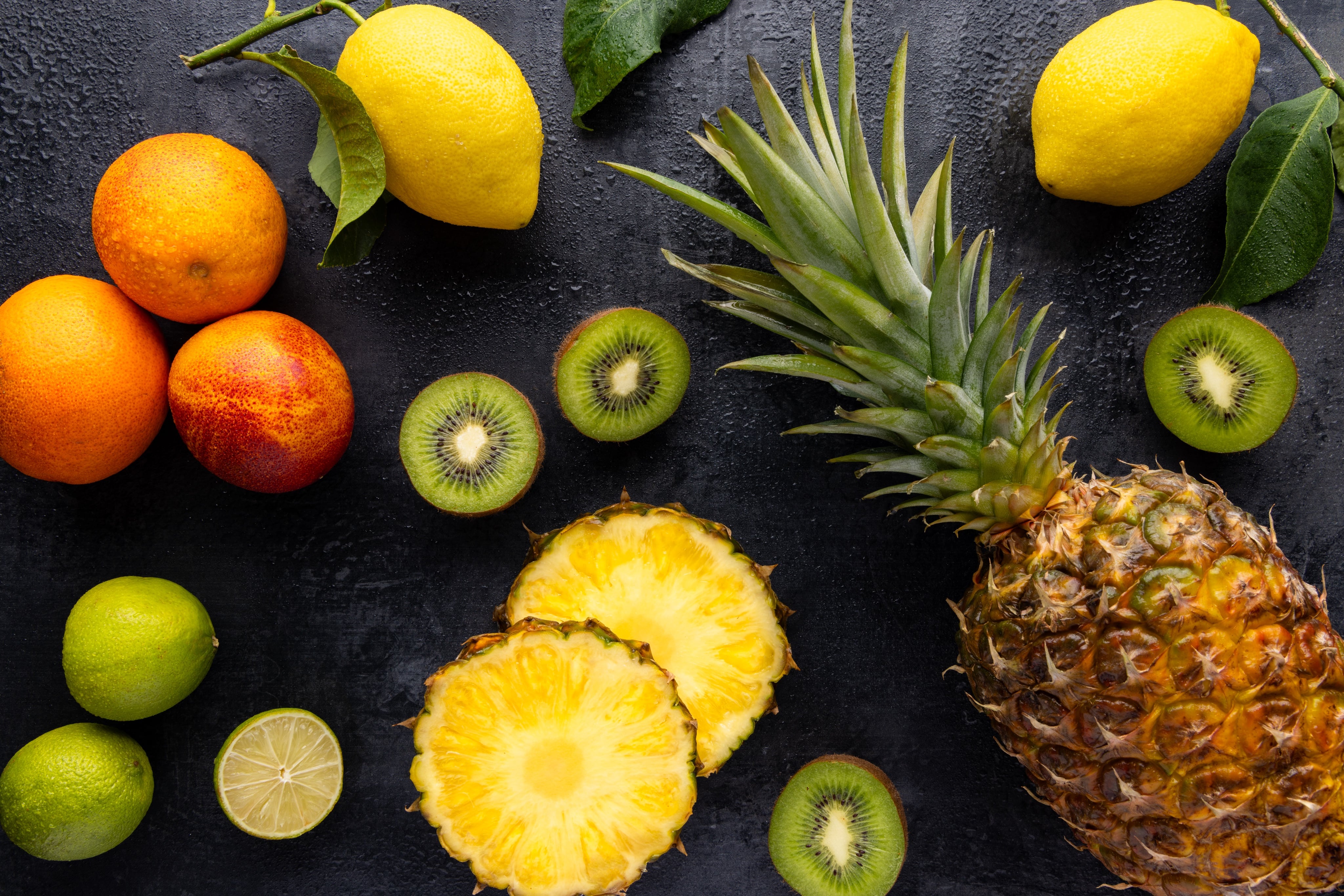 An array of juicy tropical fruit, photographed as a flay lay.  Creative food photograph by JaxMore Food and Drink Photography, shot in their Derby studio.